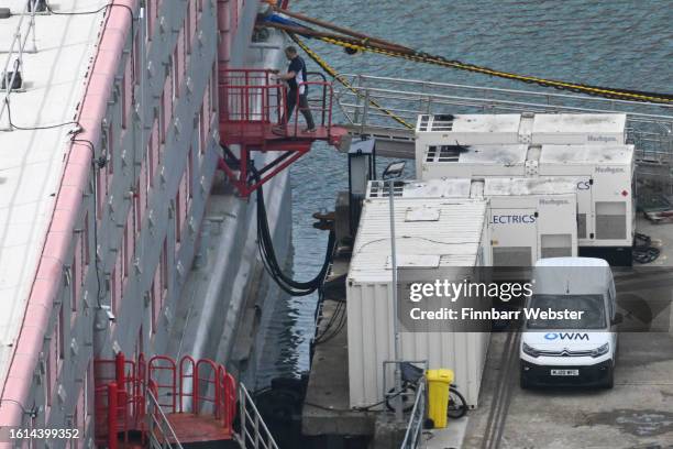 Van with the Offshore Water Management Ltd company logo displayed is seen on the pier by the Bibby Stockholm immigration barge, on August 14, 2023 in...