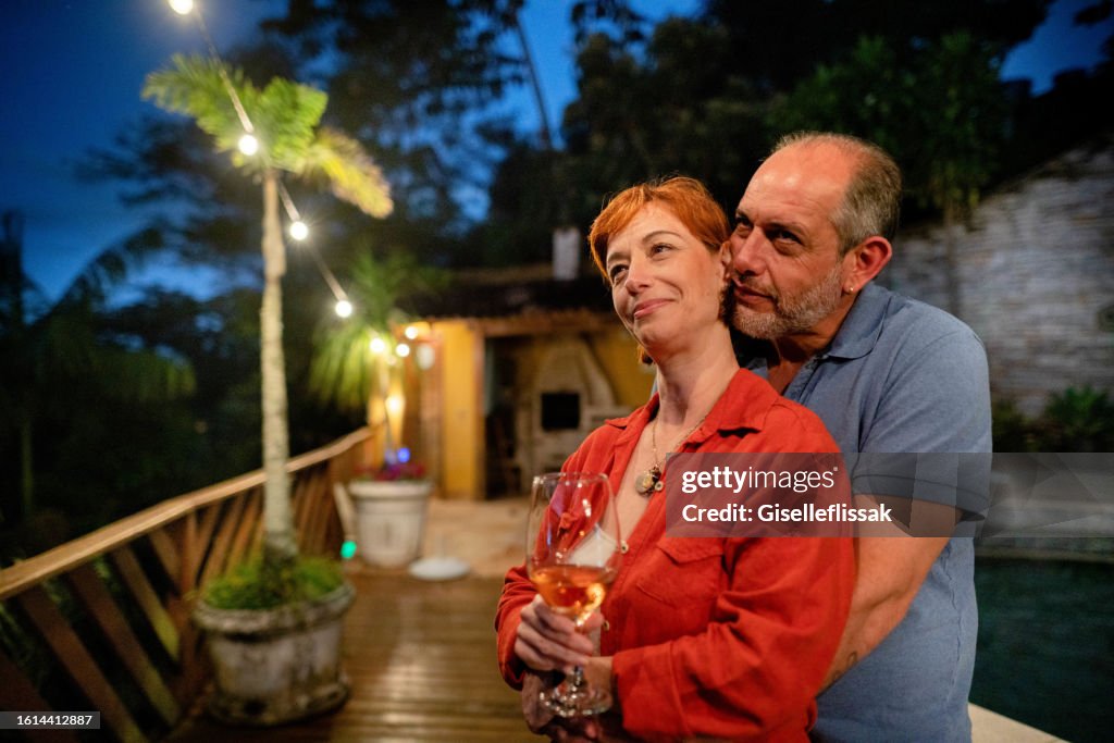 Loving mature couple enjoying the evening outside on their patio at home