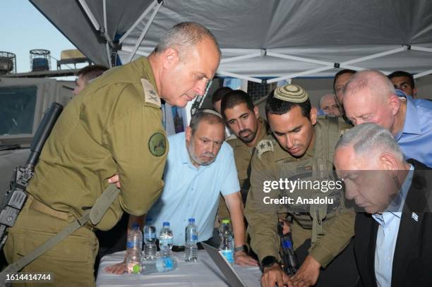 Israeli Prime Minister Benjamin Netanyahu and Israeli Defense Minister Yoav Gallant visit the site of the shooting where a settler was killed and...
