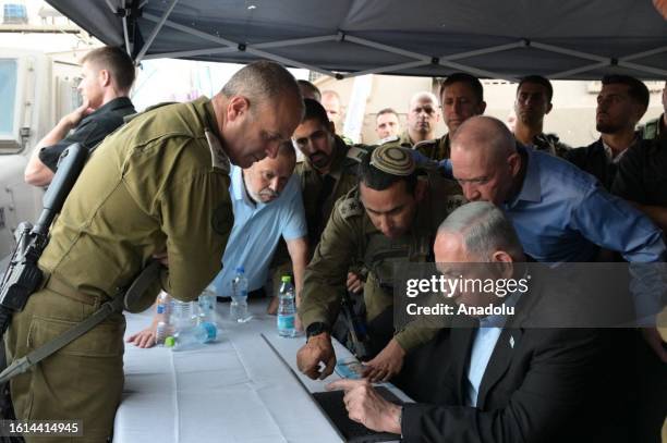 Israeli Prime Minister Benjamin Netanyahu and Israeli Defense Minister Yoav Gallant visit the site of the shooting where a settler was killed and...