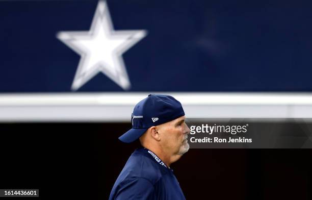 Defensive coordinator Dan Quinn of the Dallas Cowboys walks the sidelines before a preseason game against the Jacksonville Jaguars at AT&T Stadium on...