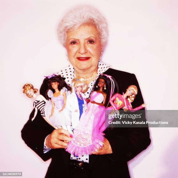 Ruth Handler, Mattel Inc. Co-founder and Barbie Doll inventor poses with a selection of Barbie Dolls.