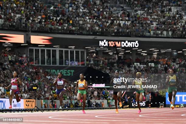 S Sha'Carri Richardson crosses the finish line past USA's Tamari Davis, Ivory Coast's Marie-Josee Ta Lou, Saint Lucia's Julien Alfred, Jamaica's...