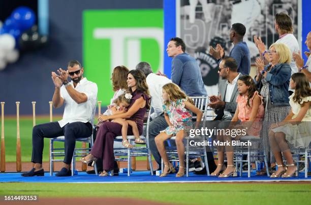 Former baseball player Jose Bautista of the Toronto Blue Jays sits with his family as he takes part in a ceremony where his name is unveiled on the...