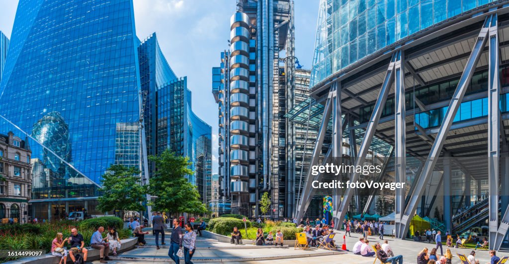 London office workers relaxing beneath futuristic City skyscrapers above