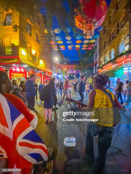 london chinatown street performers busking to crowds at night - london nightlife stock pictures, royalty-free photos & images