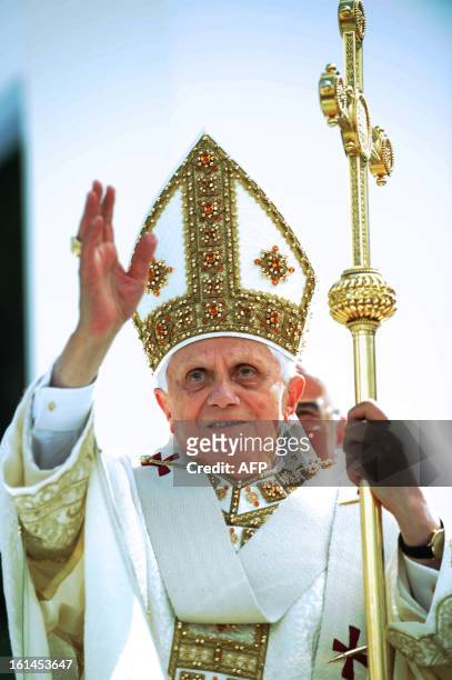 Pope Benedict XVI waves to belivers as he arrives in Piazza della Vittoria in Genoa to celebrate mass on May 18, 2008. The Pope called on governments...