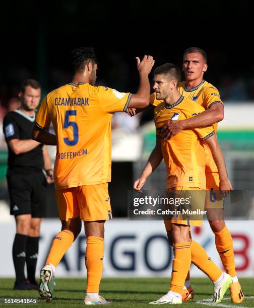 Andrej Kramaric of TSG 1899 Hoffenheim celebrates after scoring the team's first goal with teammates Ozan Kabak and Grischa Proemel during the DFB...