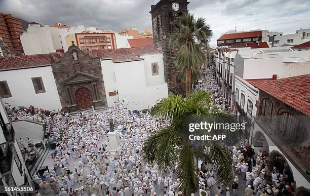 People throw talcum powder at one another as they take part in the carnival of "Los Indianos" in Santa Cruz de la Palma, on the Spanish Canary island...