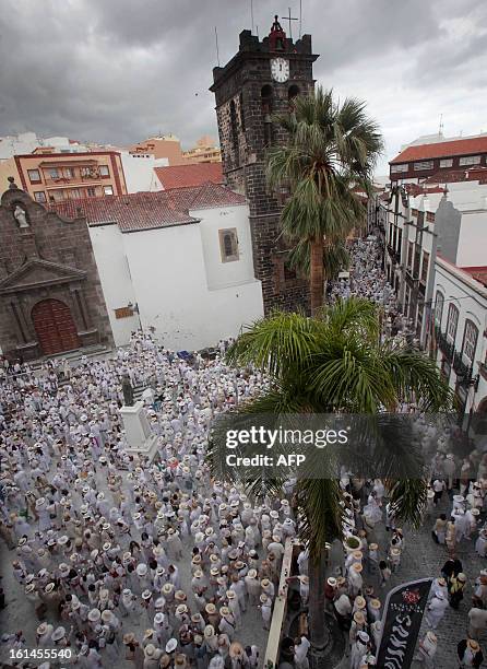 People throw talcum powder at one another as they take part in the carnival of "Los Indianos" in Santa Cruz de la Palma, on the Spanish Canary island...