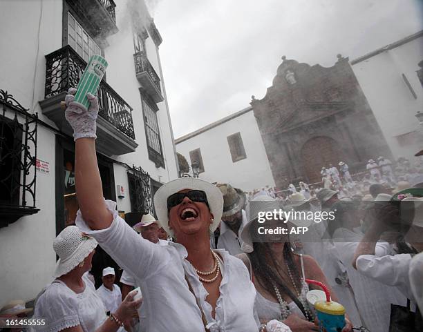 People throw talcum powder at one another as they take part in the carnival of "Los Indianos" in Santa Cruz de la Palma, on the Spanish Canary island...