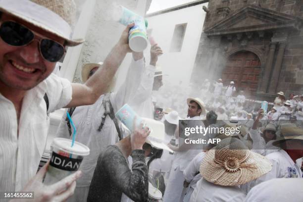 People throw talcum powder at one another as they take part in the carnival of "Los Indianos" in Santa Cruz de la Palma, on the Spanish Canary island...