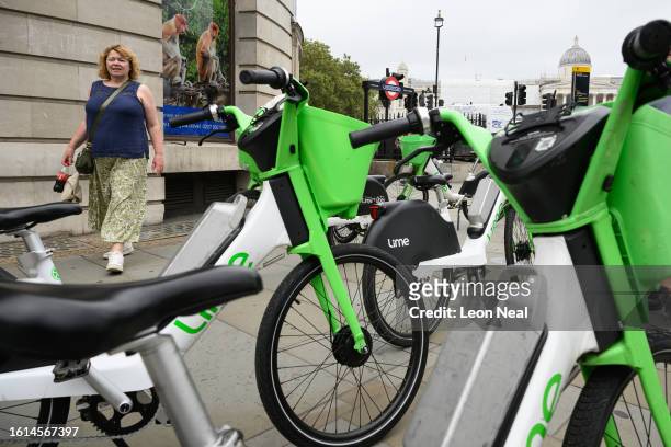 Rental e-bikes are seen parked across a pedestrian pavement on August 14, 2023 in London, England. In much of London, rental E-bikes are not required...