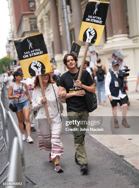 Susan Sarandon and Miles Robbins join SAG-AFTRA members as they maintain picket lines in front of Netflix on August 14, 2023 in New York City....