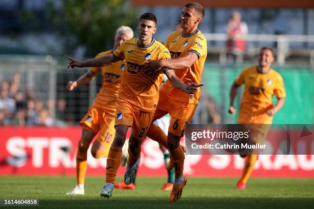 Andrej Kramaric of TSG 1899 Hoffenheim celebrates with teammates after scoring the team's second goal during the DFB cup first round match between...