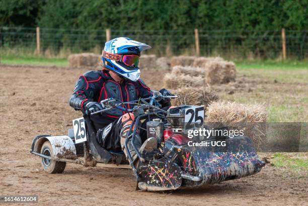 Racing lawn mower driver turns a corner in the BLMRA 500, a Le Mans style 500 mile overnight lawn mower race in a field in West Sussex, UK. The...