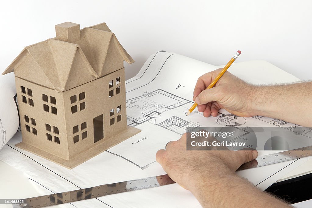 Person working on blueprint plans