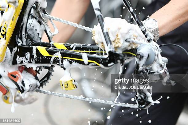 Mechanic of Kazakh cycling team Astana cleans the chain of a bicycle at Novotel hotel before a training session on July 13, 2009 in Limoges on the...