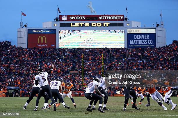 Joe Flacco of the Baltimore Ravens throws a pass behind his offensive line against Von Miller of the Denver Broncos during the AFC Divisional Playoff...