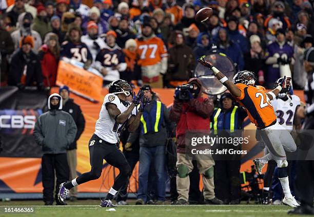Jacoby Jones of the Baltimore Ravens catches a 70-yard touchdown reception in the fourth quarter against Rahim Moore of the Denver Broncos during the...