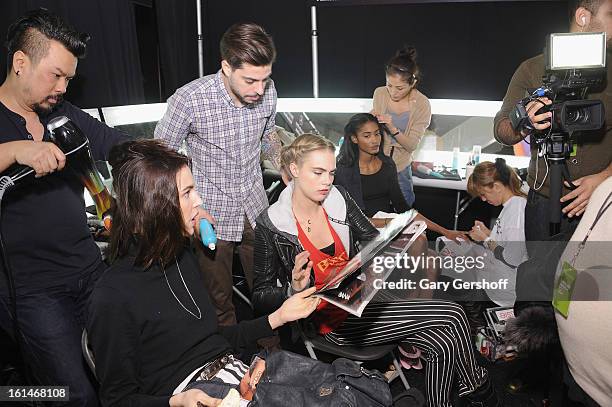 Modesl are prepared backstage at the Carolina Herrera fashion show during Fall 2013 Mercedes-Benz Fashion Week at The Theatre at Lincoln Center on...