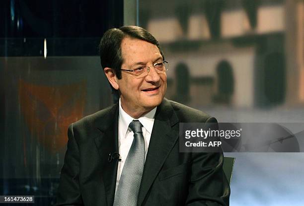 Nikos Anastasiadis sits along side Stavros Malas and George Lillikas , the three major candidates in the Cypriot presidential election, attend the...