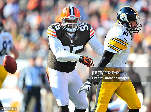 Quarterback Charlie Batch of the Pittsburgh Steelers fumbles the ball while being sacked by linebacker Juqua Parker of the Cleveland Browns during a...