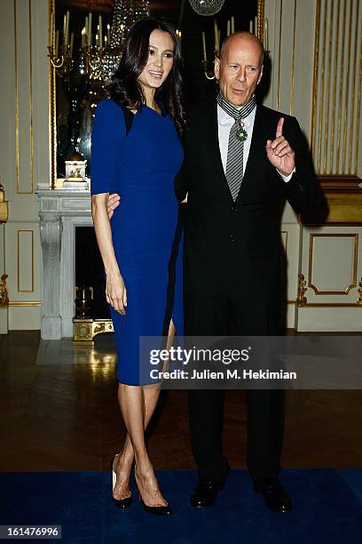 Bruce Willis poses with his wife Emma Heming-Willis after being awarded Commandeur dans l'Ordre des Arts et Lettres at Ministere de la Culture on...