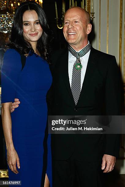 Bruce Willis poses with his wife Emma Heming-Willis after being awarded Commandeur dans l'Ordre des Arts et Lettres at Ministere de la Culture on...