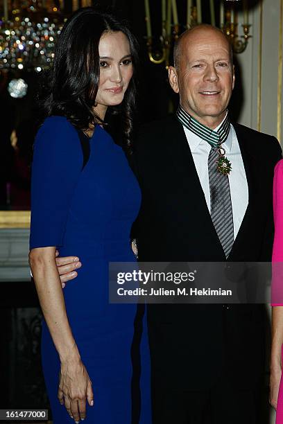 Bruce Willis poses with his wife Emma Heming-Willis after being awarded Commandeur dans l'Ordre des Arts et Lettres at Ministere de la Culture on...