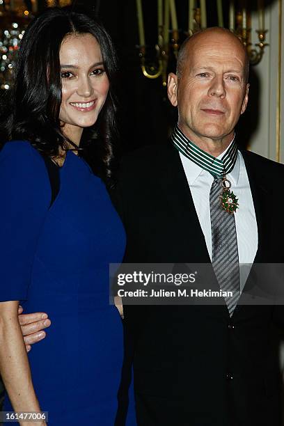 Bruce Willis poses with his wife Emma Heming-Willis after being awarded Commandeur dans l'Ordre des Arts et Lettres at Ministere de la Culture on...