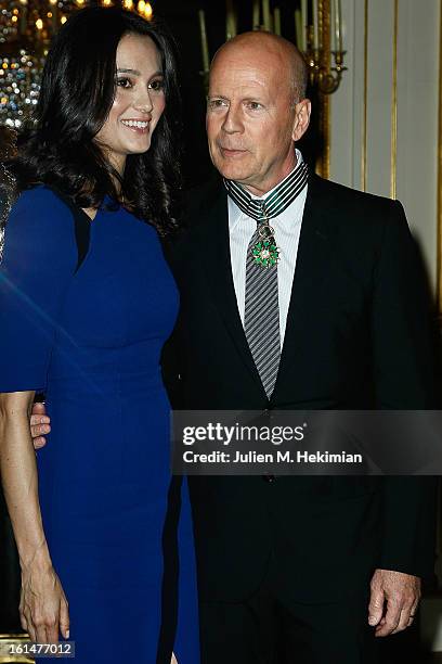 Bruce Willis poses with his wife Emma Heming-Willis after being awarded Commandeur dans l'Ordre des Arts et Lettres at Ministere de la Culture on...