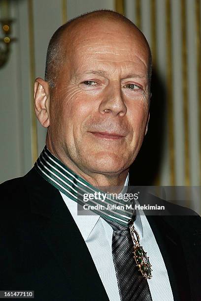 Bruce Willis poses after being awarded Commandeur dans l'Ordre des Arts et Lettres at Ministere de la Culture on February 11, 2013 in Paris, France.