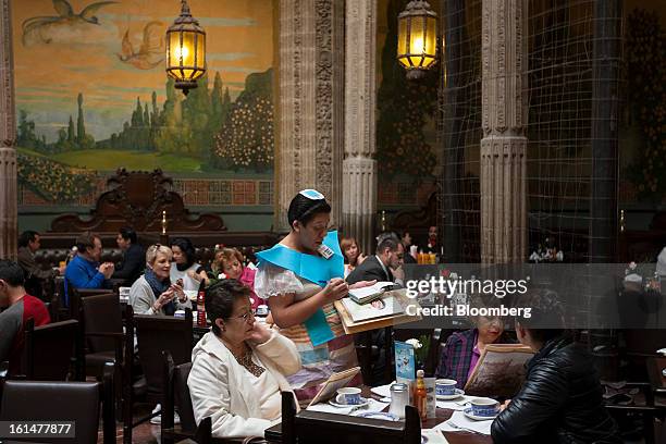 Waitress takes breakfast orders from customers inside a Grupo Sanborns SAB store in Mexico City, Mexico, on Friday, Feb. 8, 2013. Grupo Sanborns SAB,...