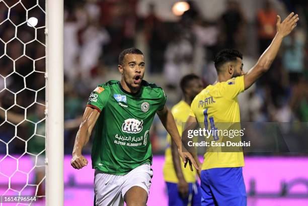 Robin Quaison of Al-Ettifaq celebrates after scoring the team's first goal during the Saudi Pro League match between Al-Ettifaq and Al Nassr at...