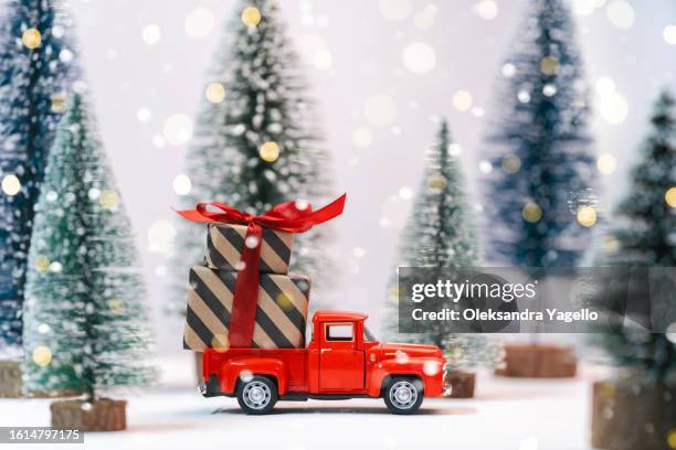 miniature red car delivering holiday fir tree. - christmas truck bildbanksfoton och bilder