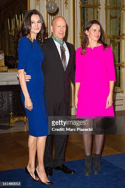 Bruce Willis poses with his wife Emma Heming-Willis and French minister of Culture Aurelie Filipetti after being awarded 'Commandeur dans l'Ordre des...