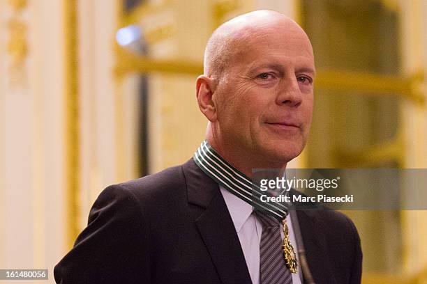 Bruce Willis poses after being awarded 'Commandeur dans l'Ordre des Arts et Lettres' at Ministere de la Culture on February 11, 2013 in Paris, France.