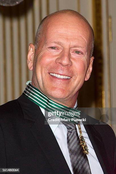 Bruce Willis poses after being awarded 'Commandeur dans l'Ordre des Arts et Lettres' at Ministere de la Culture on February 11, 2013 in Paris, France.