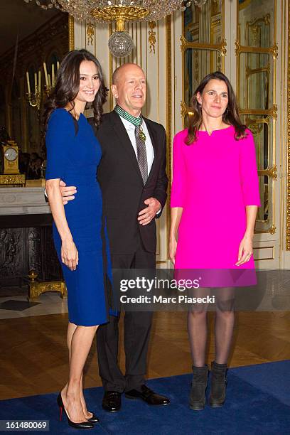 Bruce Willis poses with his wife Emma Heming-Willis and French minister of Culture Aurelie Filipetti after being awarded 'Commandeur dans l'Ordre des...