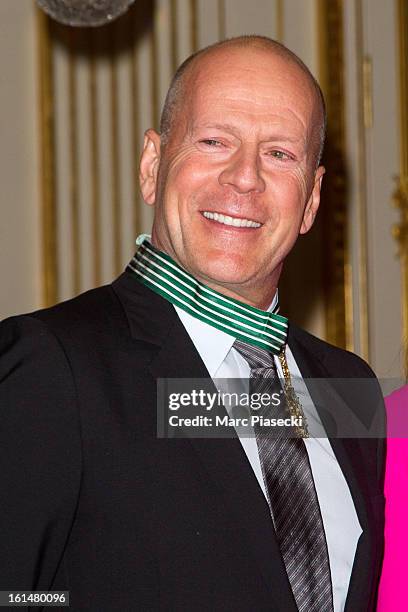 Bruce Willis poses after being awarded 'Commandeur dans l'Ordre des Arts et Lettres' at Ministere de la Culture on February 11, 2013 in Paris, France.