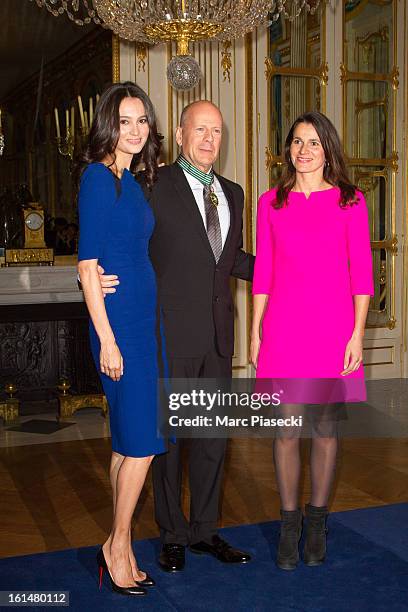 Bruce Willis poses with his wife Emma Heming-Willis and French minister of Culture Aurelie Filipetti after being awarded 'Commandeur dans l'Ordre des...