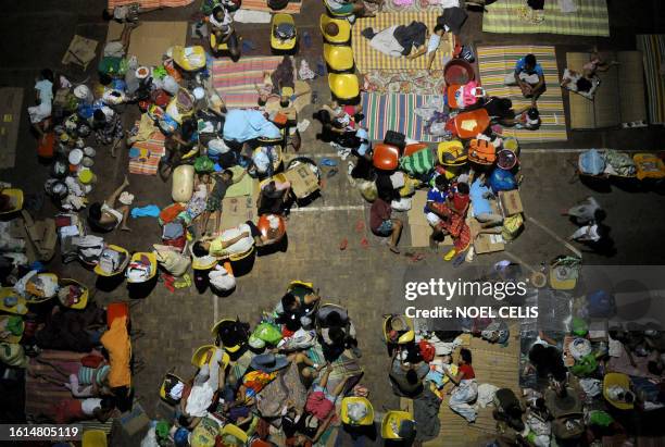 Flash flood victims sleep on a gymnasium in Iligan City, southern Philippines on the christmas eve on December 24, 2011. Thousands of people in the...