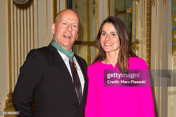 Bruce Willis poses with French minister of Culture Aurelie Filipetti after being awarded 'Commandeur dans l'Ordre des Arts et Lettres' at Ministere...