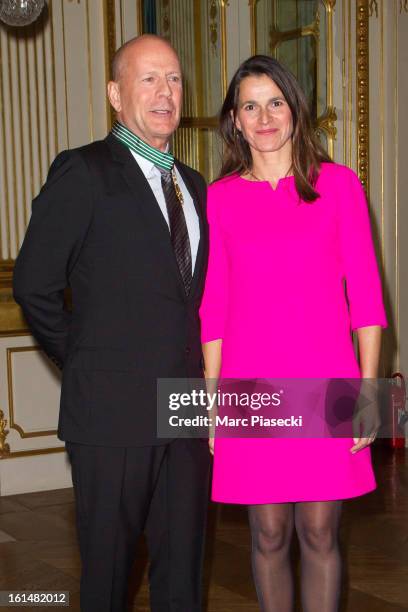 Bruce Willis poses with French minister of Culture Aurelie Filipetti after being awarded 'Commandeur dans l'Ordre des Arts et Lettres' at Ministere...