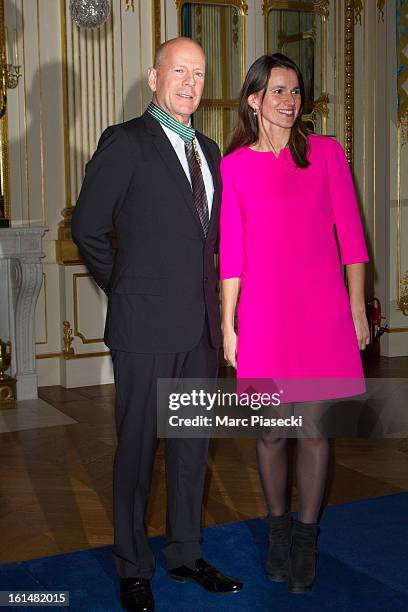 Bruce Willis poses with French minister of Culture Aurelie Filipetti after being awarded 'Commandeur dans l'Ordre des Arts et Lettres' at Ministere...