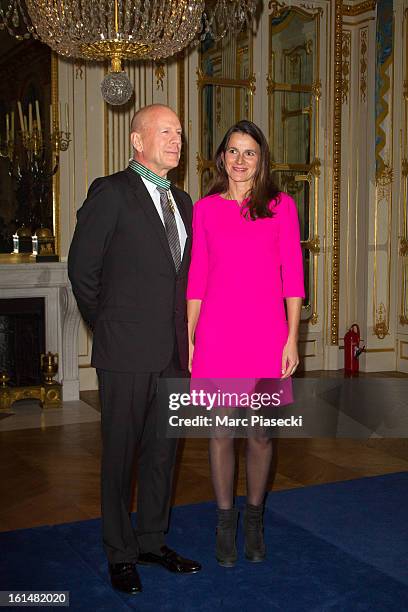 Bruce Willis poses with French minister of Culture Aurelie Filipetti after being awarded 'Commandeur dans l'Ordre des Arts et Lettres' at Ministere...