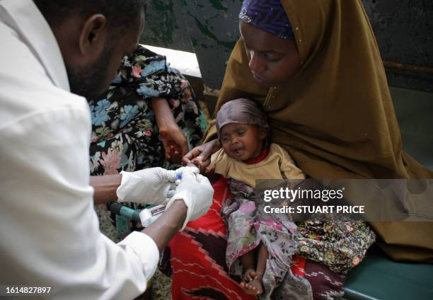 In a photograph released by the African Union-United Nations Information Support Team on August 10, 2011 malnourished and dehydrated baby cries as a...