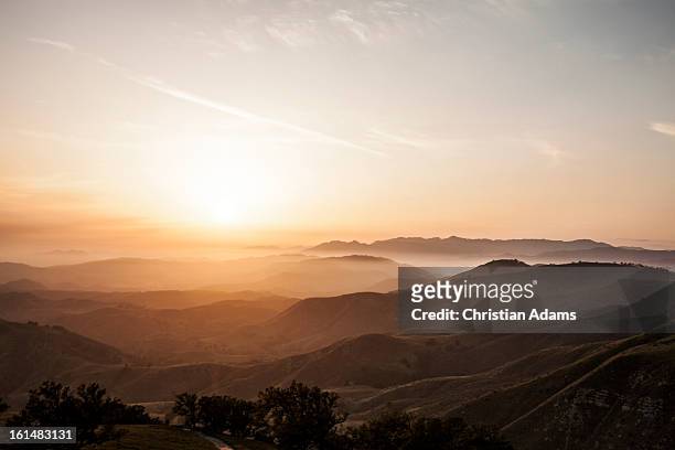 rolling hills at sunset - rolling landscape stock pictures, royalty-free photos & images