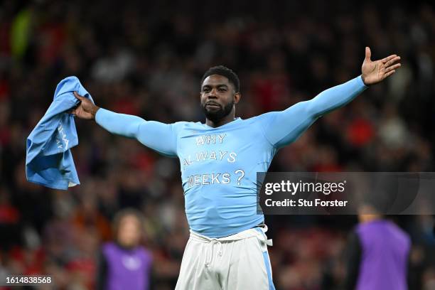 Micah Richards reacts as he takes part in a penalty shootout on the pitch at half-time during the Premier League match between Manchester United and...